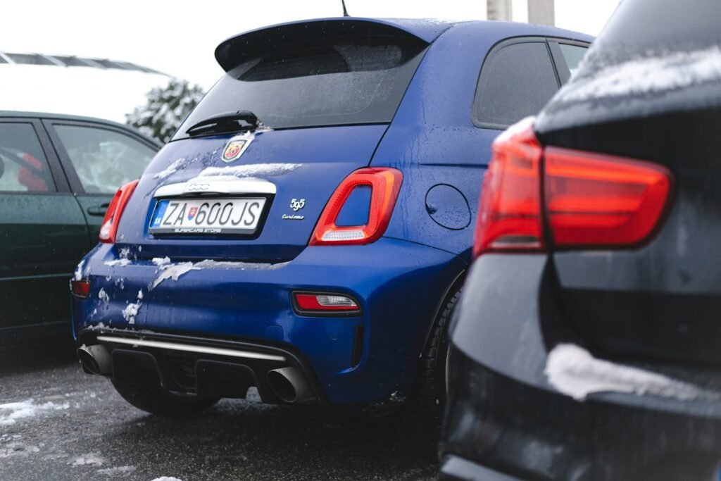 a couple of cars parked next to each other in a parking lot